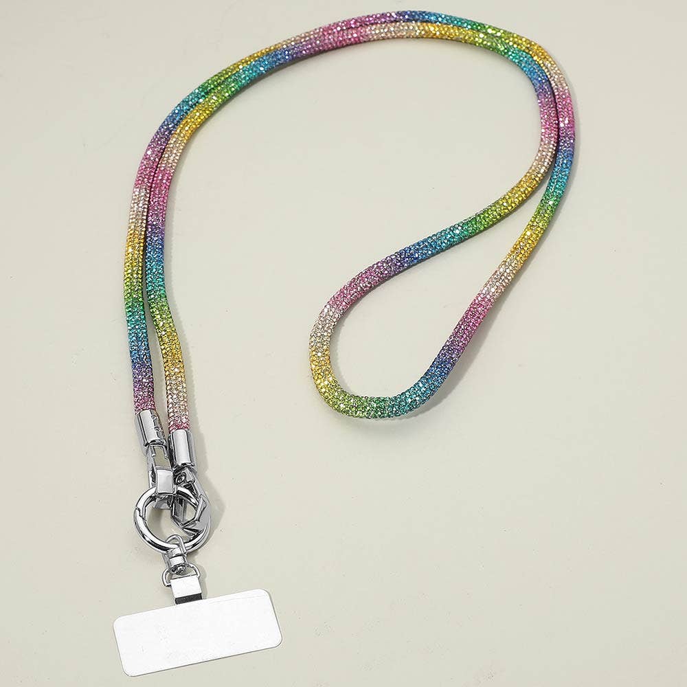 The Sensibling Corp. Rhinestone Phone Lanyard Necklace features a vibrant, rainbow-hued beaded design with a sturdy metal clip and a blank white ID badge attached, displayed on a light surface; this versatile accessory also serves as a chic cell phone holder for enhanced convenience.