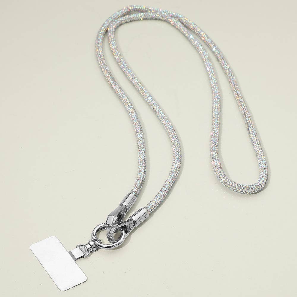 A sparkling, textured Rhinestone Phone Lanyard Necklace by Sensibling Corp. features a silver cord reminiscent of rhinestone straps and a clasp holding a blank rectangular badge.