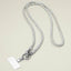 A sparkling, textured Rhinestone Phone Lanyard Necklace by Sensibling Corp. features a silver cord reminiscent of rhinestone straps and a clasp holding a blank rectangular badge.
