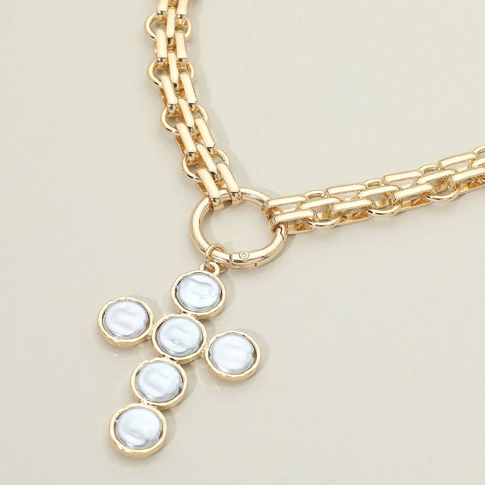 Sensibling Corp.’s Pearl Cross Charm Pendant Chunky Chain Statement Necklace features a textured gold chain with a round clasp and a striking cross pendant crafted from five circular white pearls set in gold.