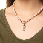 A person wearing a green top displays the WJW Stainless Steel Chunky Glass Bead Carabiner Necklace around their neck.