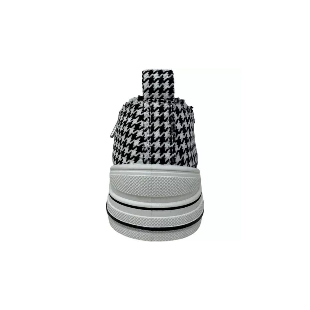 Centered on a plain white background, this image highlights the rear view of the VERY G Aman Tailor Houndstooth Sneaker, featuring a classic black and white houndstooth pattern, a crisp white rubber sole, and a practical pull tab at the heel.