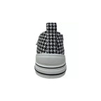 Centered on a plain white background, this image highlights the rear view of the VERY G Aman Tailor Houndstooth Sneaker, featuring a classic black and white houndstooth pattern, a crisp white rubber sole, and a practical pull tab at the heel.