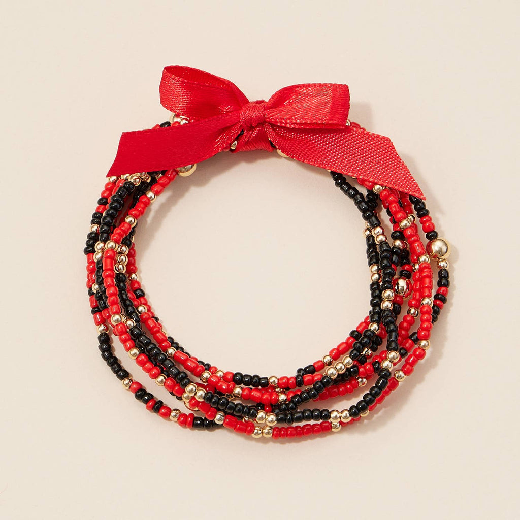 Game Day Seed Beaded Bracelet Set consisting of red, black, and gold seed bead stretch bracelets tied together with a red ribbon bow.