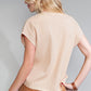 Seen from behind, an individual wears a beige Shewin Patch Pocket Ribbed Knit Short Sleeve Sweater paired with a brown skirt, demonstrating a stylish and comfortable ensemble perfect for transitional weather.