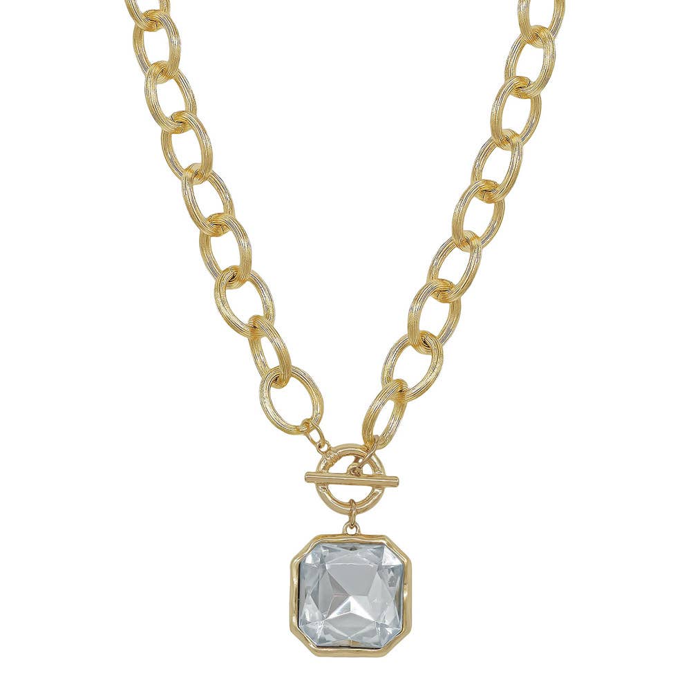 Faire CHUNKY TEXTURED CHAIN TOGGLE 25MM STONE PENDANT: a gold-tone chunky chain necklace featuring a toggle clasp and a large, square faceted clear stone pendant.