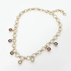 Elevate your style with Sensibling Corp.’s 14K Gold Plated Colorful Round CZ Charm Station Chunky Chain Necklace, featuring chunky circular links adorned with seven dangling round and teardrop-shaped multi-colored cubic zirconia charms—a playful yet elegant accessory displayed on a white background, perfect for adding a vibrant pop of color to any look.