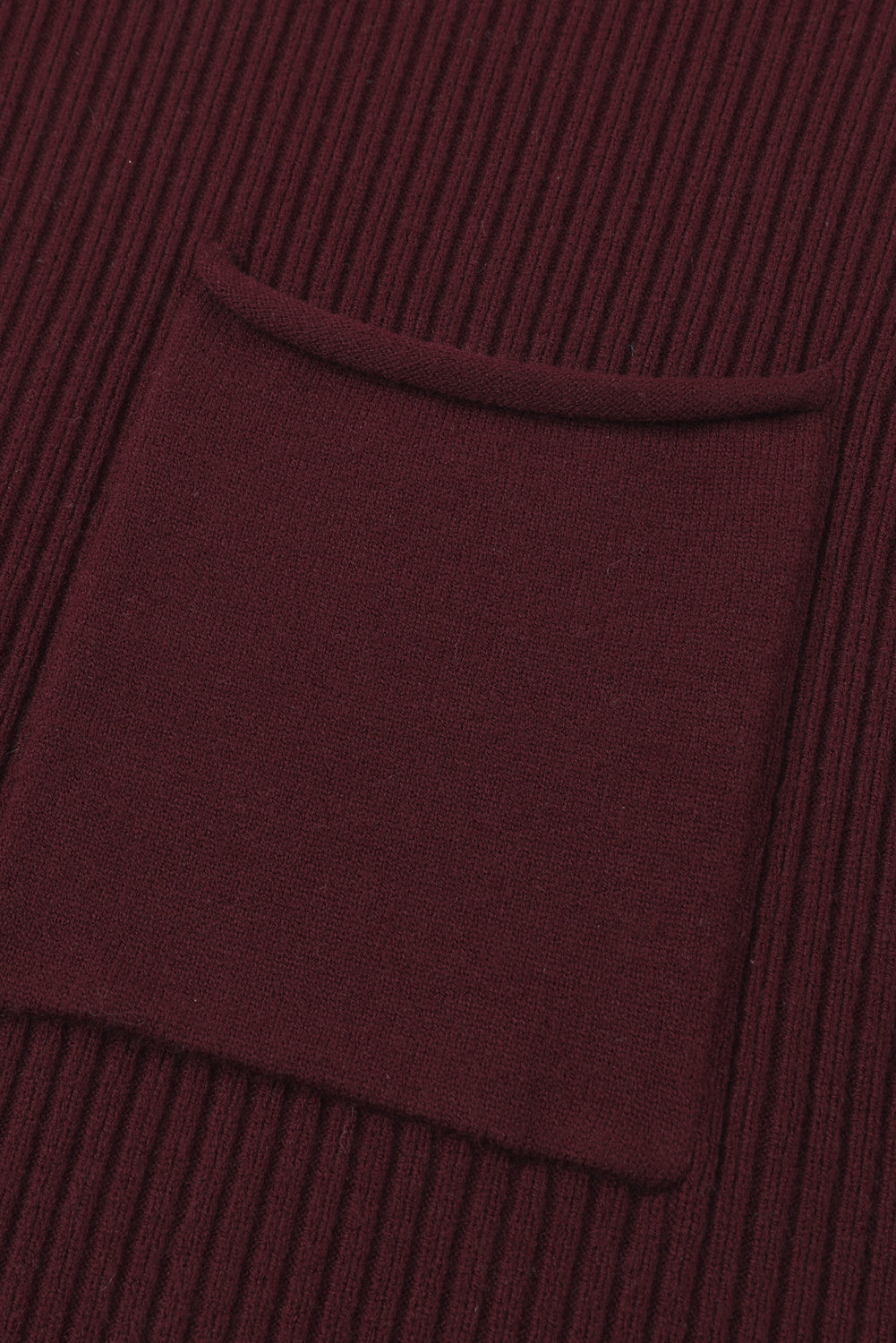 Close-up of the Shewin Patch Pocket Ribbed Knit Short Sleeve Sweater in maroon, showcasing its textured fabric and square pocket, ideal for transitional weather and casual style.