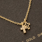 The Anarchy Street Secret Box Gold Dipped Cz Cross Pendant Necklace showcases two cross pendants—one plain, one sparkling with cubic zirconia—beautifully displayed against a textured dark background.