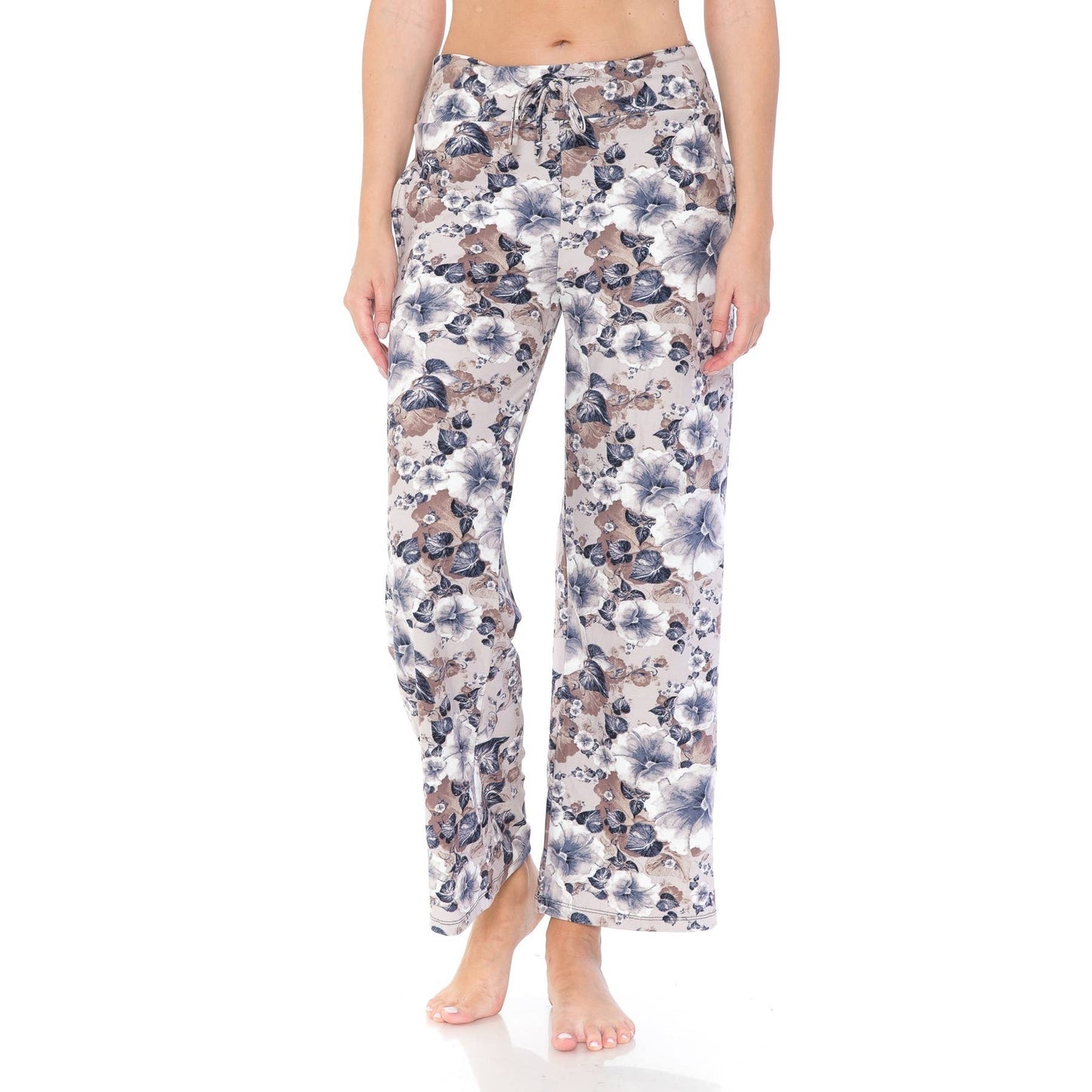 Someone stands barefoot against a plain white background, wearing Leggings Depot's Buttery Soft Print Pajama Pants featuring an elastic waistband and a colorful floral pattern.