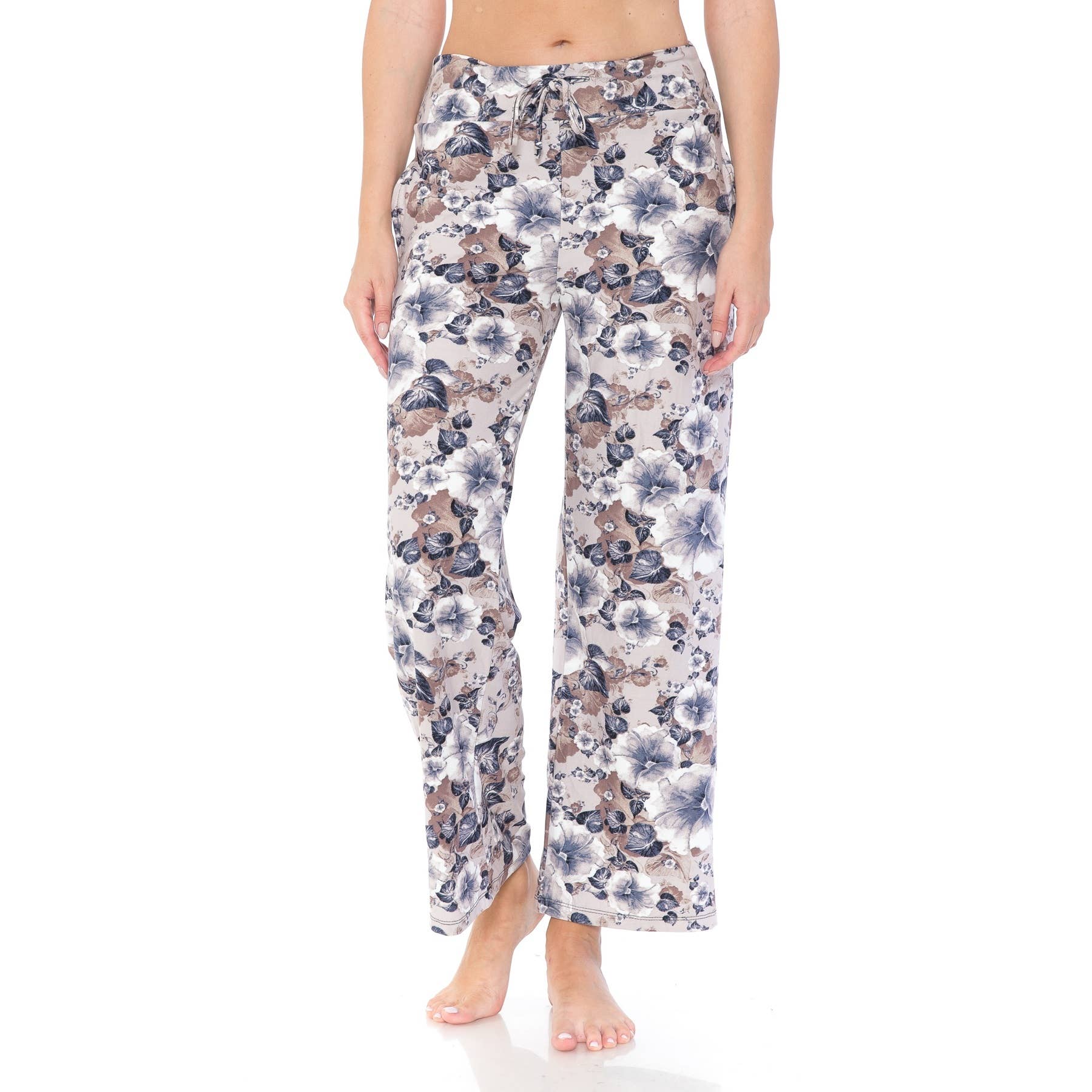 Someone stands barefoot against a plain white background, wearing Leggings Depot's Buttery Soft Print Pajama Pants featuring an elastic waistband and a colorful floral pattern.