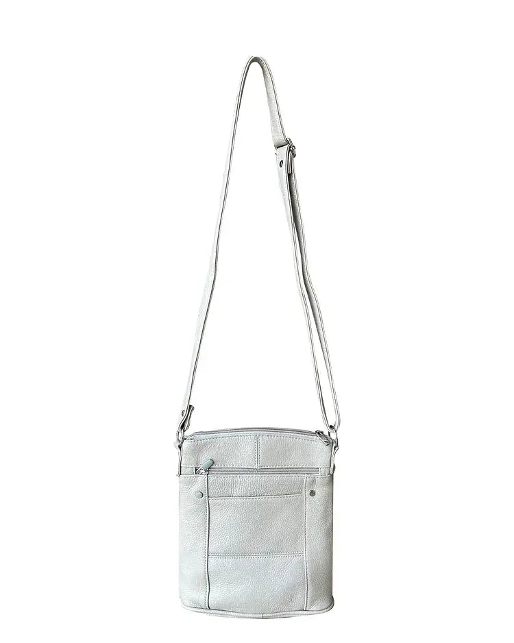 The Roma Leathers, Inc. Cowhide leather crossbody features light gray cowhide leather, an adjustable shoulder strap, a front zippered pocket, and stitched detailing. Photographed on a white background.