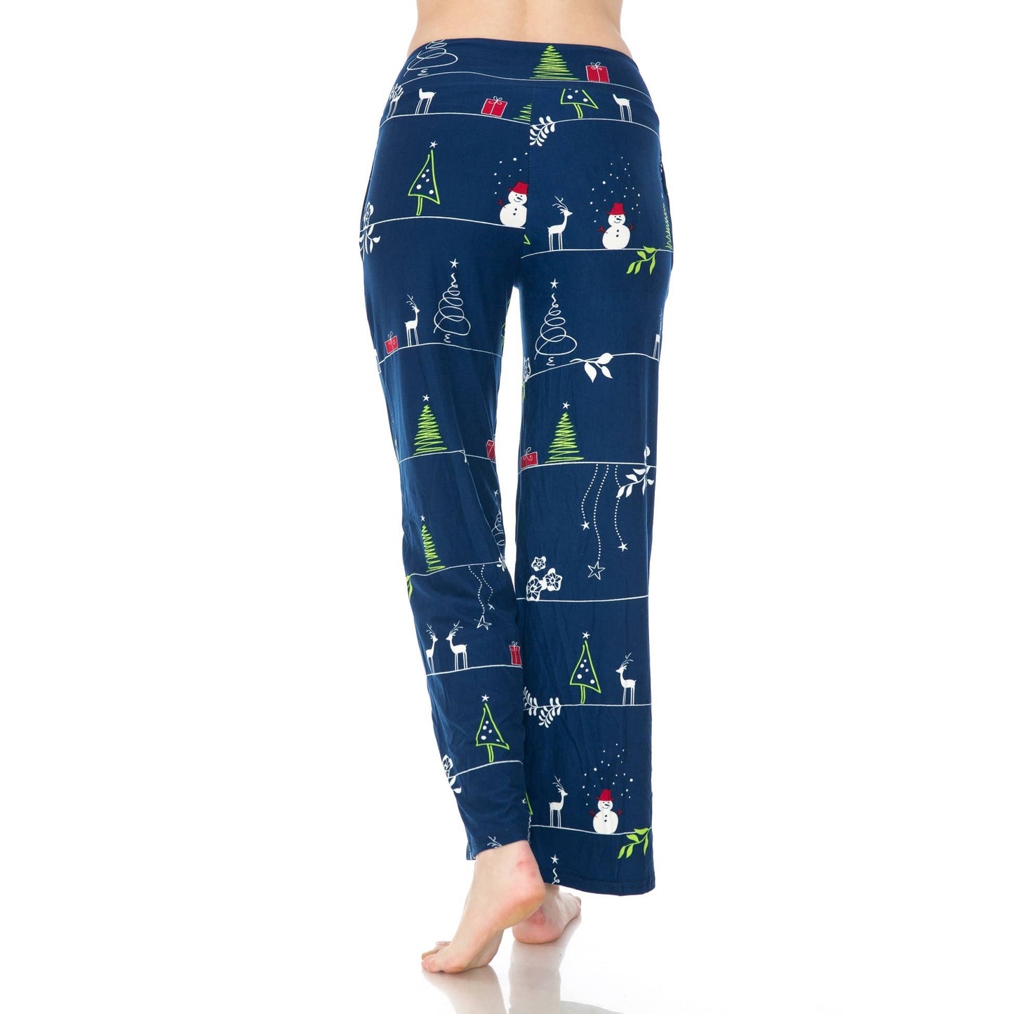 A person stands barefoot on a white background wearing Leggings Depot Buttery Soft Print Pajama Pants with Christmas-themed prints and an elastic waistband.