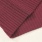 Close-up of a folded maroon Patch Pocket Ribbed Knit Short Sleeve Sweater by Shewin, ideal for a modern casual look, resting on a light surface.