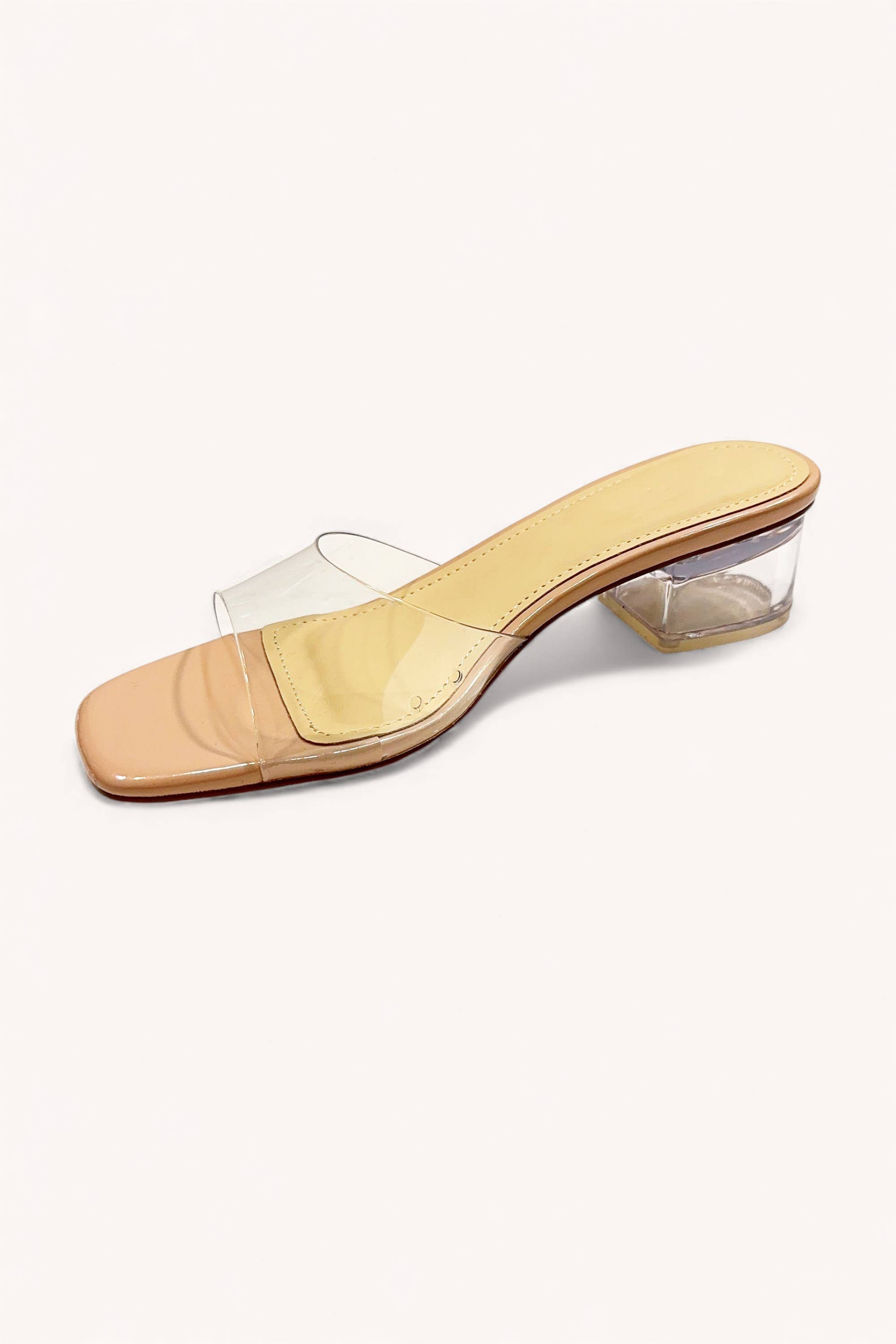 The CCOCCI Clear Slip On Slide Block Heel features a single beige sandal with a transparent block heel and clear toe strap, shown on a white background—an elegant, chic addition to any modern wardrobe. Main image