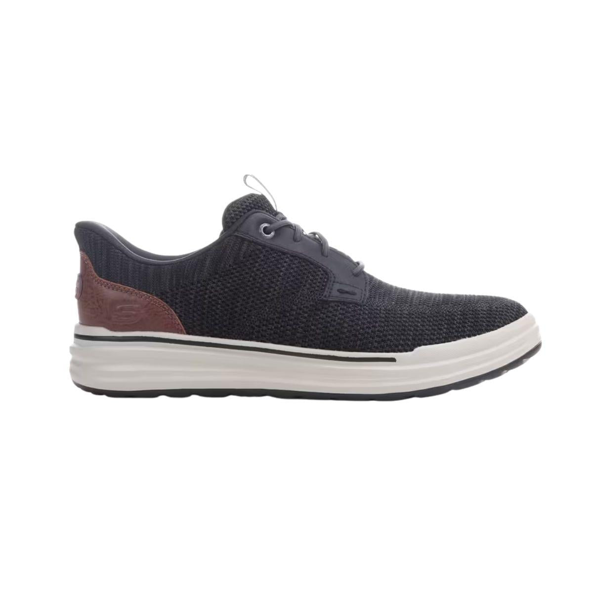 The SKECHERS Slip-ins Relaxed Fit Sterling - Ramone features a black and white knit upper, a lace-up front, brown heel detail, and a thick white sole—displayed in a side profile on a plain background. This versatile sneaker offers the perfect blend of style and comfort you expect from men’s casual shoes, with the relaxed fit signature to Skechers Slip-ins.