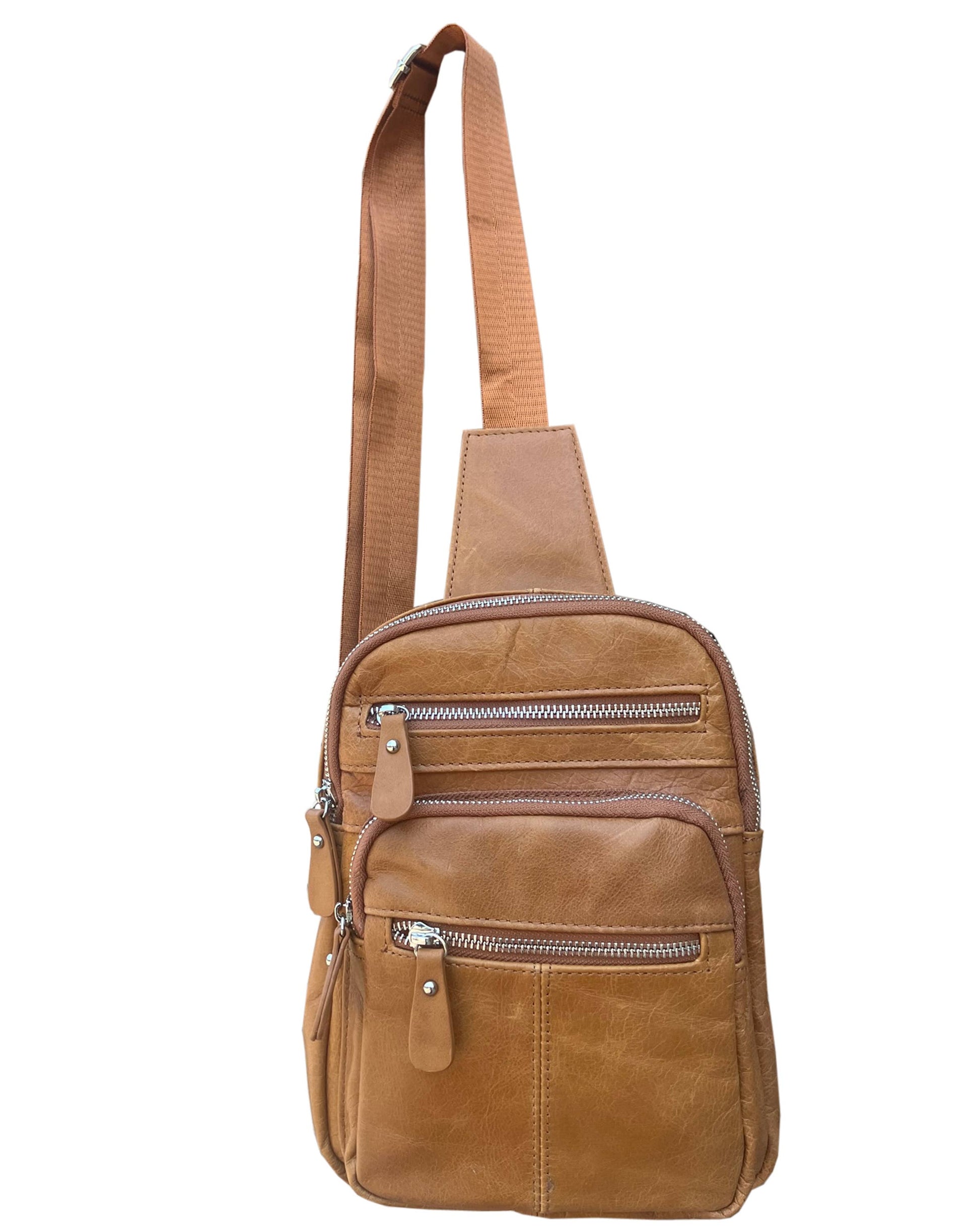The Roma Leathers, Inc. Cowhide leather sling bag backpack features two main zippered compartments, front zipper pockets, and an adjustable shoulder strap for a comfortable fit.