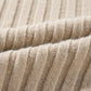 Close-up of the beige ribbed fabric with a textured, wavy pattern showcases rib-knit details similar to Shewin's Khaki Cable Knit Colorblock Crew Neck Drop Shoulder Sweater.