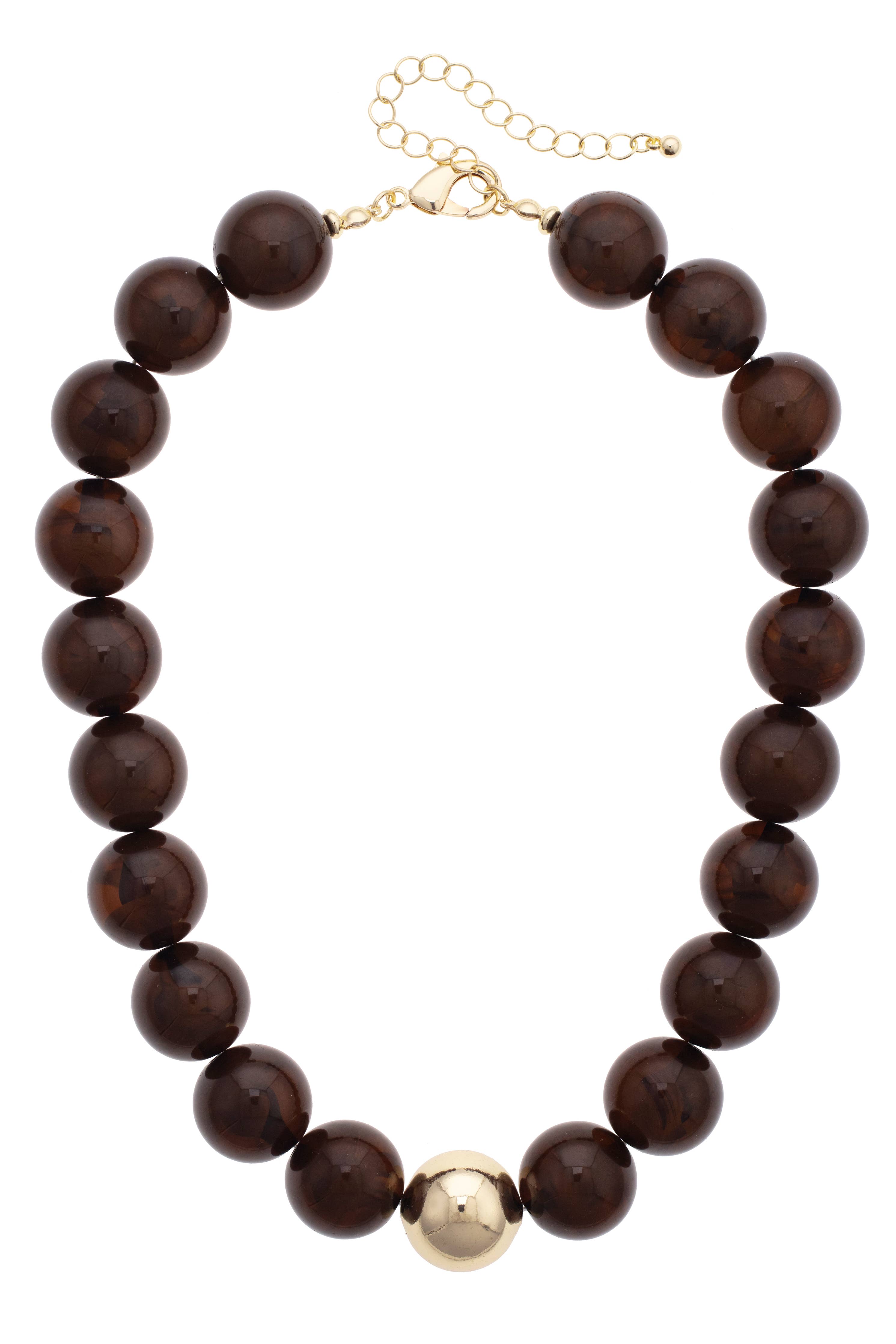 The Marjorie Fall Beaded Necklace by Canvas Style features oversized dark brown resin beads, a single central gold bead, and is finished with a gold chain extender and clasp.
