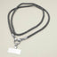 A Sensibling Corp. Rhinestone Phone Lanyard Necklace featuring metallic clasps and a blank rectangular identification badge is displayed on a light-colored surface.