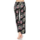 A person stands barefoot, facing away, wearing Leggings Depot Buttery Soft Print Pajama Pants featuring colorful sugar skulls and a comfy elastic waistband.