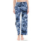 A person wears Leggings Depot’s Buttery Soft Print Pajama Pants in a high-waisted blue and white tie-dye style with a drawstring elastic waistband, standing barefoot against a plain white background.