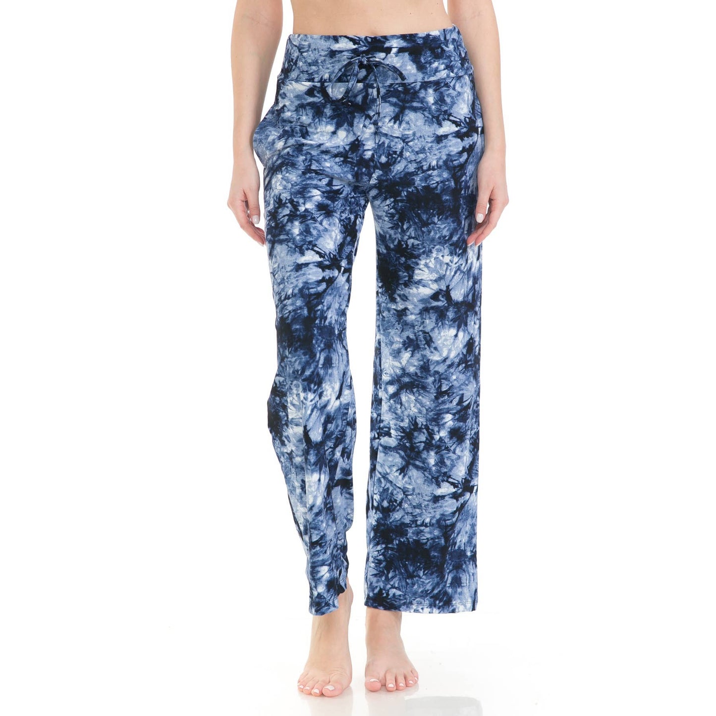 A person wears Leggings Depot’s Buttery Soft Print Pajama Pants in a high-waisted blue and white tie-dye style with a drawstring elastic waistband, standing barefoot against a plain white background.