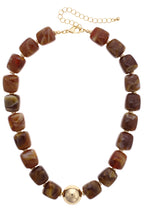 Palermo Resin Beaded Necklace featuring square, marbled brown resin beads and a central gold-tone ball, finished with an adjustable gold-tone chain extender and lobster clasp.