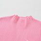 Close-up of the Patch Pocket Ribbed Knit Short Sleeve Sweater by Shewin, a versatile pink knit sweater with a round neckline and pocket, set against a light gray background.