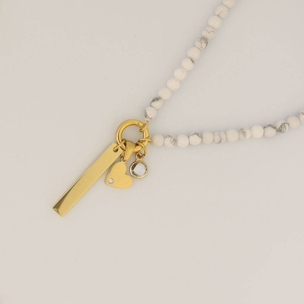 Introducing the WJW Semi Precious Natural Stone Charm Keeper Necklace, an elegant piece adorned with three enchanting gold charms—a rectangular bar, a petite heart, and a round gem. Each charm is expertly crafted with 18K Gold PVD coated accents, beautifully displayed against a neutral backdrop.