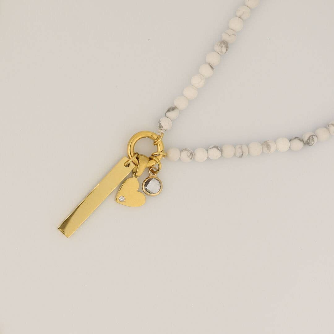 Introducing the WJW Semi Precious Natural Stone Charm Keeper Necklace, an elegant piece adorned with three enchanting gold charms—a rectangular bar, a petite heart, and a round gem. Each charm is expertly crafted with 18K Gold PVD coated accents, beautifully displayed against a neutral backdrop.