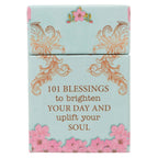 The Box of Blessings Promises for Women by Christian Art Gifts features a light blue box adorned with gold decorative swirls, pink flowers, and the words "101 blessings to brighten your day and uplift your soul." Inside are inspiring Bible verse cards highlighting God's promises especially for women.