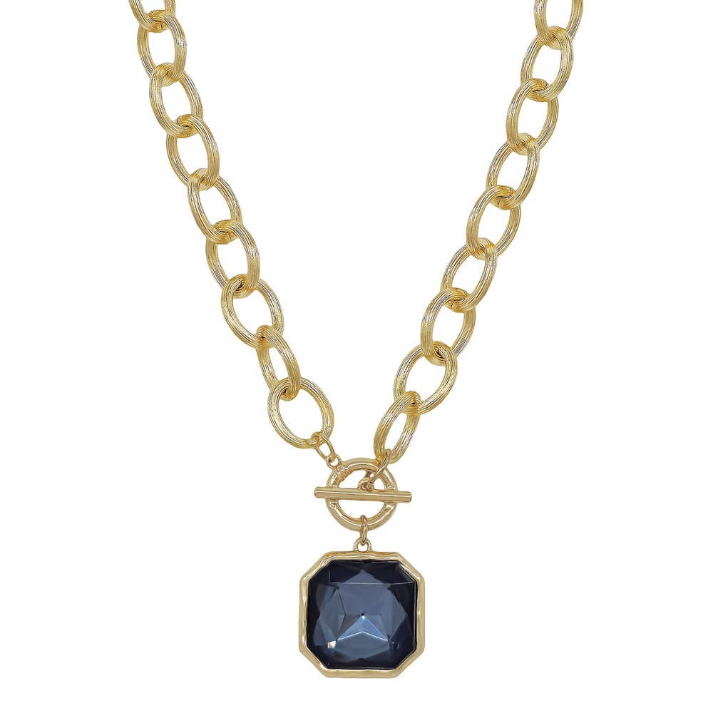 Faire CHUNKY TEXTURED CHAIN TOGGLE 25MM STONE PENDANT: a gold-tone chunky chain necklace with a toggle clasp and an octagonal dark blue stone pendant. Main image