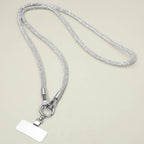 A Rhinestone Phone Lanyard Necklace by Sensibling Corp., featuring a rectangular blank name tag, displayed on a light beige background.