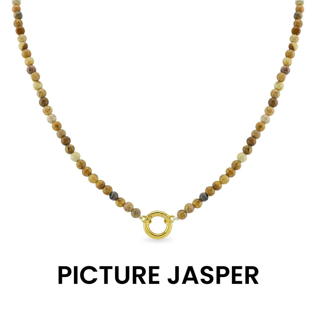 Introducing the WJW Semi Precious Natural Stone Charm Keeper Necklace, crafted with round, earth-toned Picture Jasper beads and highlighted by a central 18K Gold PVD Coated clasp. Presented on a white background, this necklace seamlessly combines the natural elegance of semi precious stones with luxurious gold accents.