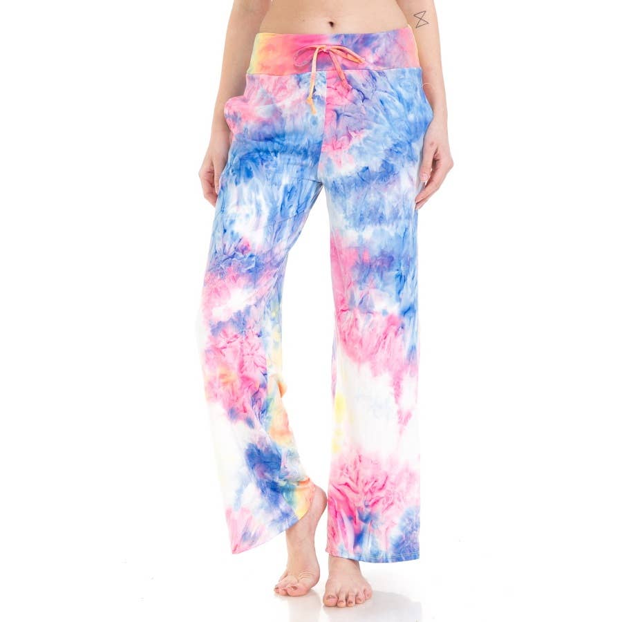 A person wearing Leggings Depot’s Buttery Soft Print Pajama Pants with a blue, pink, and white tie dye pattern and elastic waistband stands barefoot against a white background.