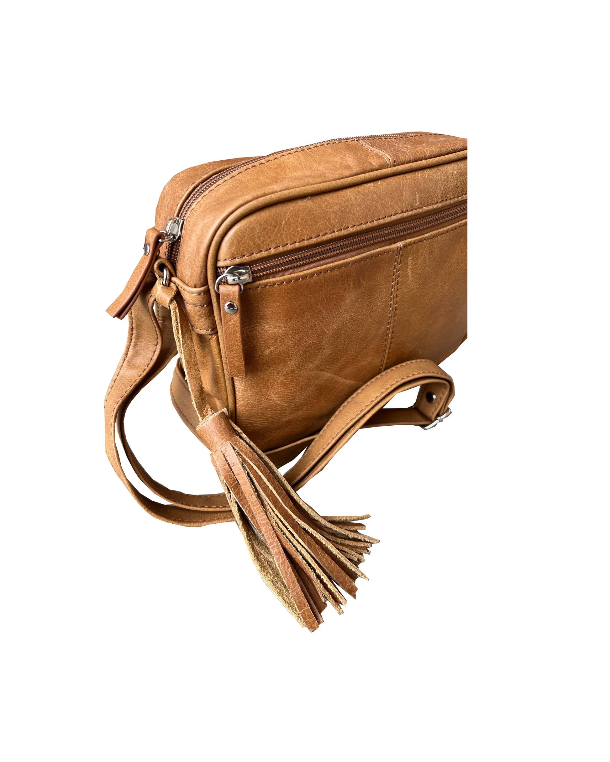 Roma Leathers, Inc. Cowhide Leather Crossbody in light brown features a front zipper pocket, silver hardware, and a tassel on the adjustable strap, shown on a white background.