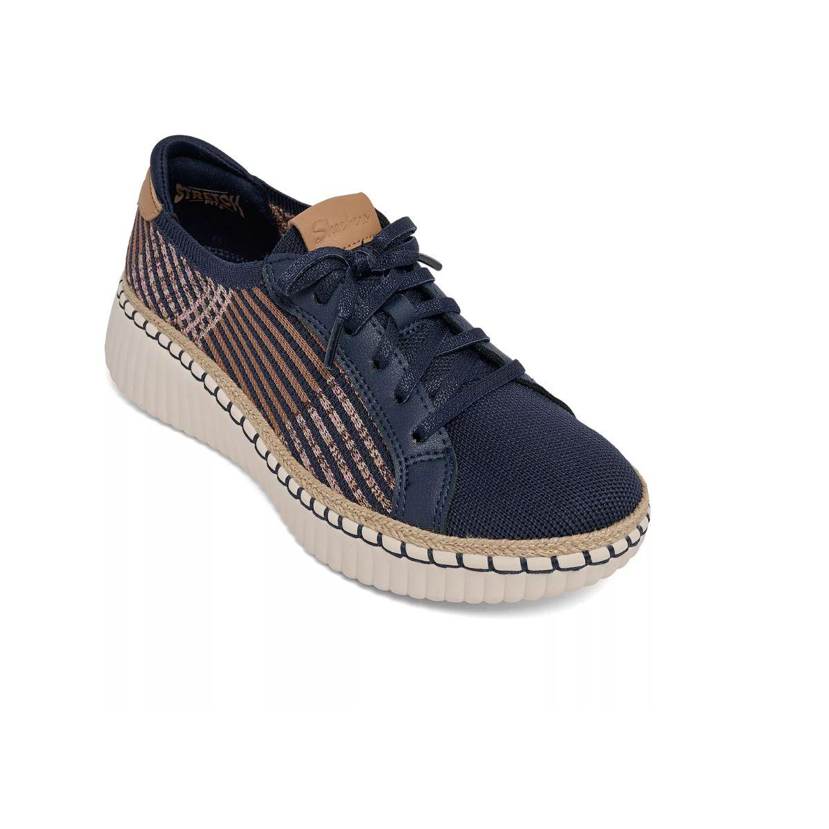 The SKECHERS Wilshire Boulevard Breezy Stroll Navy Sneaker features brown accents, a striped side detail, white ribbed sole, and laces, and is photographed on a white background to showcase its lightweight comfort. Main image