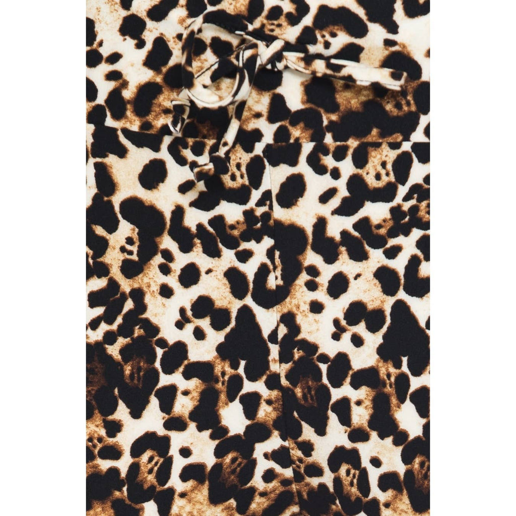 Close-up of Leggings Depot Buttery Soft Print Pajama Pants with a brown, black, and white animal print, featuring an elastic waistband and a drawstring bow.