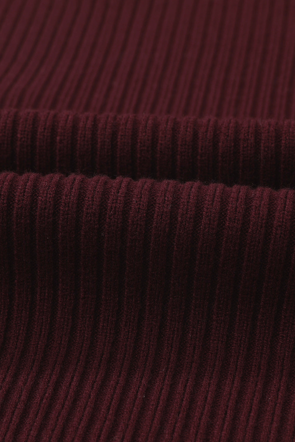 Close-up of Patch Pocket Ribbed Knit Short Sleeve Sweater by Shewin, displaying burgundy texture and folds.