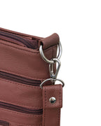 Close-up of the Roma Leathers, Inc. Cowhide leather crossbody featuring a metal clasp on a ring, visible zipper details, textured cowhide material, and zippered pockets.