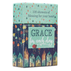 The Box of Blessings Grace for Each Day by Christian Art Gifts is a decorative box featuring raindrop and house designs, with "100 showers of blessing for your heart" printed on the lid and "GRACE for each day" on the front. It is filled with inspirational verses and Scripture cards to uplift your spirit.