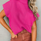 The Shewin Patch Pocket Ribbed Knit Short Sleeve Sweater in vibrant pink, featuring a mock neck and pocket, is an ideal transitional piece paired with high-waisted brown pants against a sleek gray background.