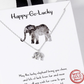 A Tiny Elephant Pendant necklace by SPECIAL EFFECTS, presented on a card adorned with an illustrated elephant and the text "Happy-Go-Lucky" at the top. The necklace features a delicate 16" silver chain and an elegant "White Gold Dipped" stamp.
