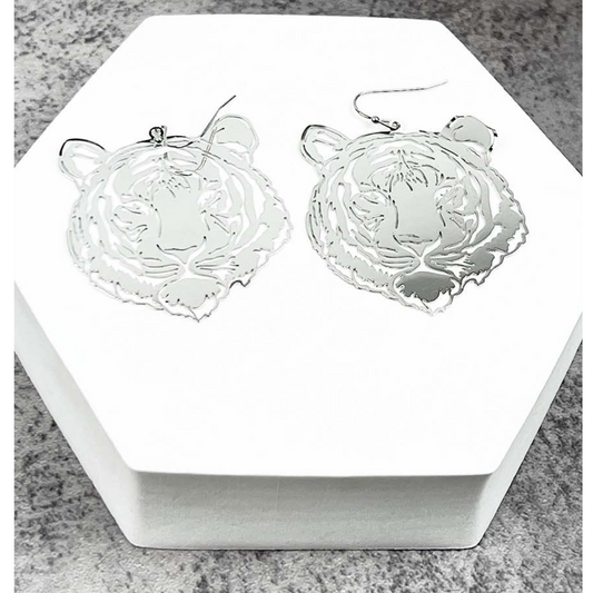 The ITS ME10288 TIGER earrings by SPECIAL EFFECTS are two silver tiger shapes displayed on a white hexagonal stand.