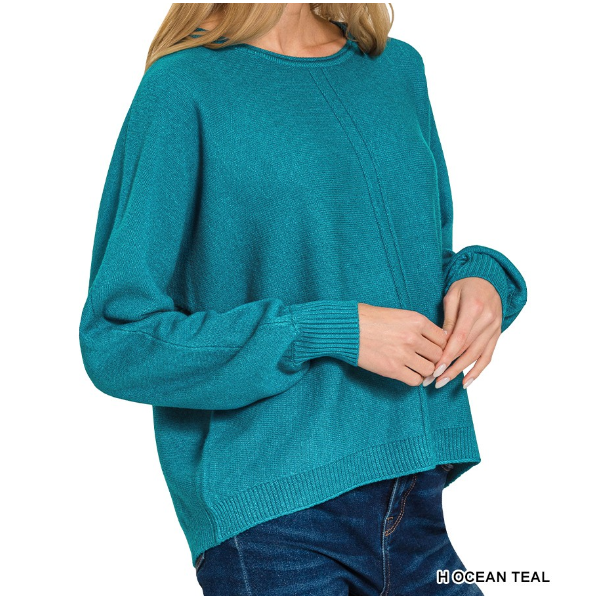 A person wears the Zenana Viscose Front Seam Round Neck Sweater, featuring long sleeves and ribbed cuffs and hem in teal, paired with dark blue jeans.