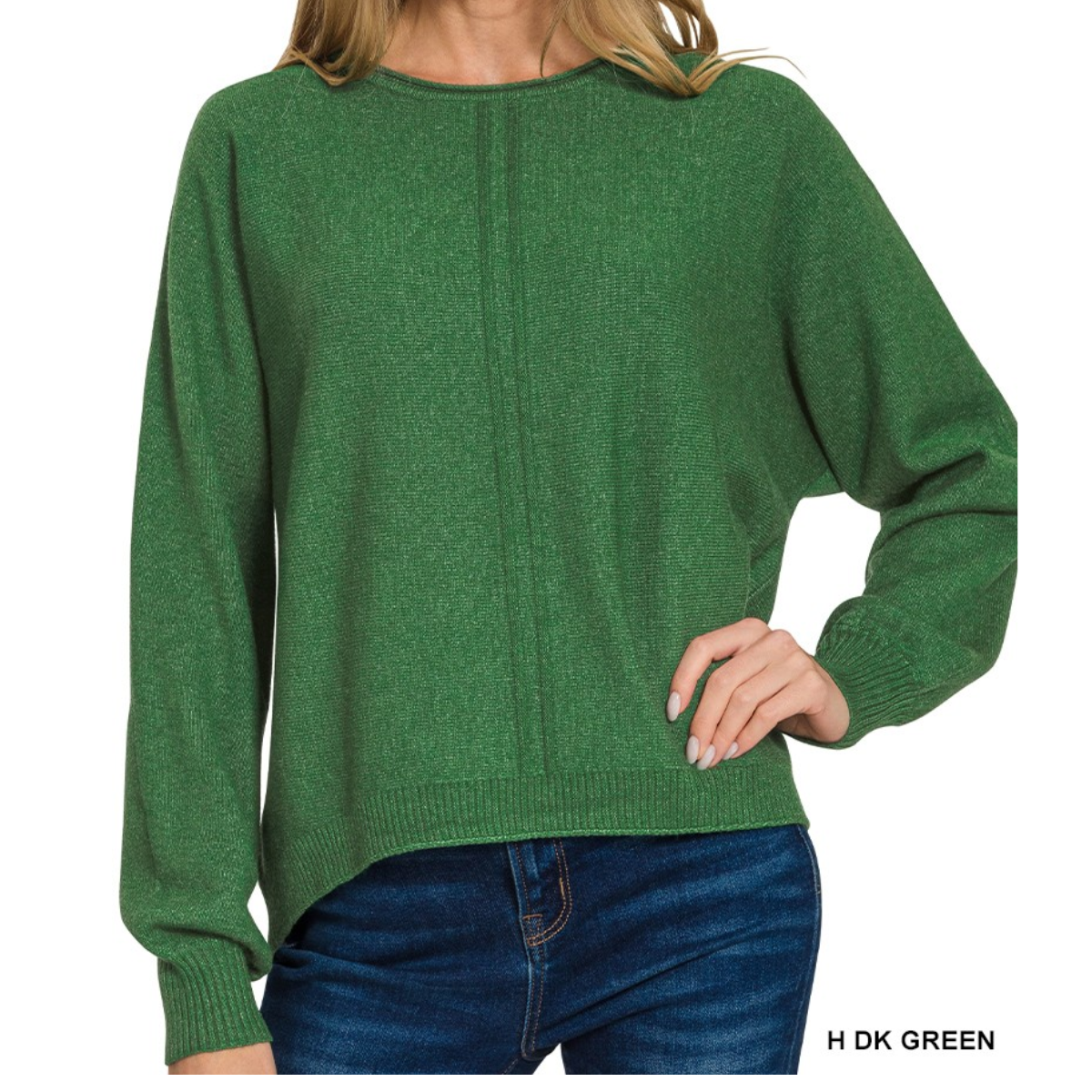 A person wearing a Zenana Viscose Front Seam Round Neck Sweater in dark green with long sleeves and blue jeans, posing with one hand on their hip.