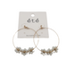 The Crystal Flower Hoop Earrings by SPECIAL EFFECTS showcase a timeless design with gold hoops, intricate white flowers, and sparkling crystals, elegantly presented on an "été" branded card.