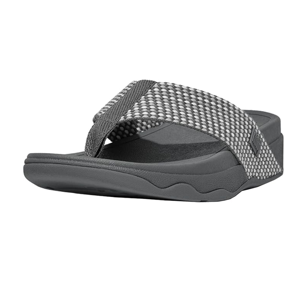 The Surfa Women's Flip Flop by FIT FLOPS in Pewter, designed by FITFLOP USA LLC, is showcased against a white background. This sandal features a textured strap in gray and black with a cushioned midsole and contoured footbed for enhanced long-lasting comfort.