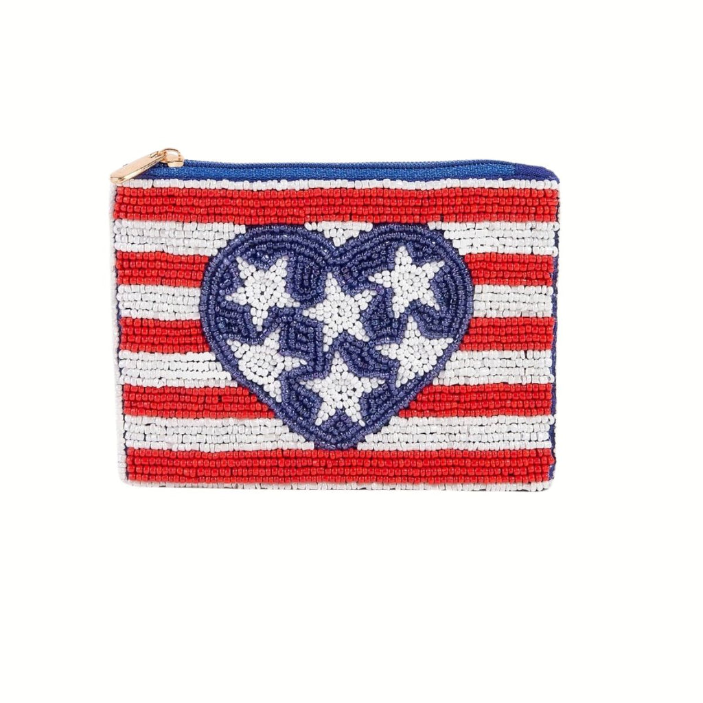 The Seed Bead Accented Mini Pouch Bag Assorted by Wona Trading features red and white horizontal stripes, a central blue heart with white stars, and a blue zipper—making it a charming fashion accessory gift.